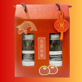 The red gift box from Craft & Culture - Kombucha, Kefir & Probiotics Singapore includes two jars with fish and lantern graphics. Labeled as "Jasmine Osmanthus Fermented Honey Kumquats" and "Passionfruit Peach Fermented Honey Kumquats," these antioxidant-rich treats feature vibrant orange fruit icons below.