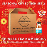 A promotional image for Craft & Culture's "Chinese Tea Kombucha Series - The Specialties - Kombucha Set 2" features a cardboard box labeled "Kombucha, Kefir & Probiotics Singapore" and a Da Hong Pao Kombucha bottle. Text highlights flavors: Red Robe, Gaoshan Green Tea, and White Peach Oolong Green Tea Kombucha.